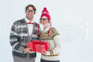 Geeky hipster couple holding present