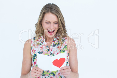 Smiling woman reading love letter