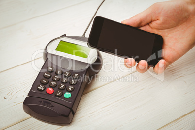 Man using smartphone to express pay