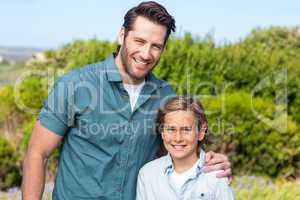 Father and son smiling at camera