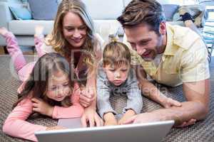 Happy family using the laptop