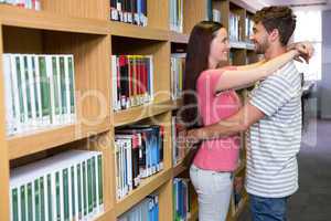 Cute couple embracing each other in the library