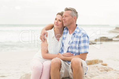 Casual couple sitting on rock