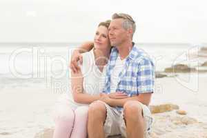 Casual couple sitting on rock
