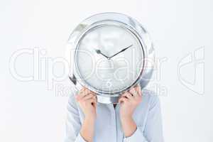 Businesswoman in suit holding a clock