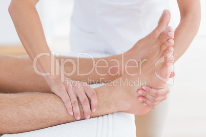 Physiotherapist doing foot massage