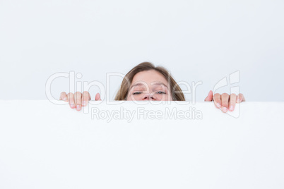 Woman looking top of poster