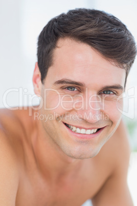 Smiling patient lying on massage table and looking at camera