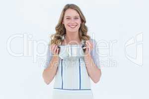 Smiling woman holding saucepan