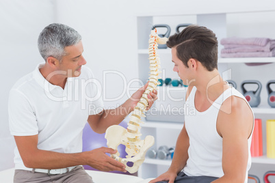 Doctor showing anatomical spine to his patient