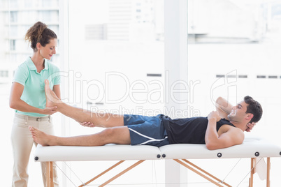 Doctor examining man leg