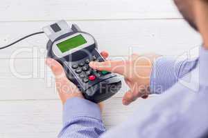 Man entering his pin on terminal