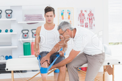 Doctor examining his patient back legs