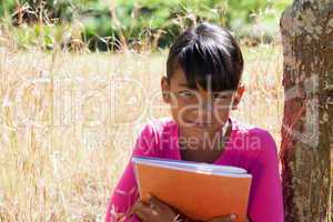 Cute little girl reading in park