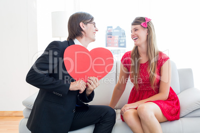 Cute geeky couple with red heart shape