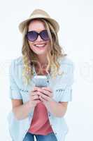 Smiling woman texting with her smartphone