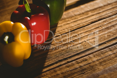 Three peppers on chopping board Three peppers on chopping board