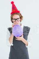Geeky hipster blowing up balloon