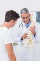 Doctor explaining anatomical spine to his patient