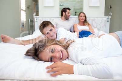 Happy family on the bed reading book