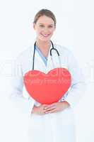 Doctor holding red heart card