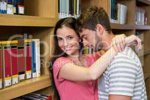 Cute couple embracing each other in the library