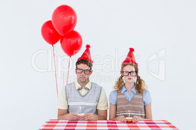 Geeky hipster couple celebrating his birthday