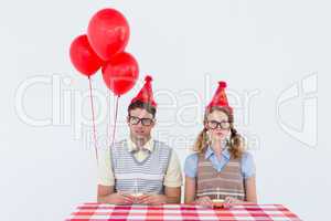 Geeky hipster couple celebrating his birthday