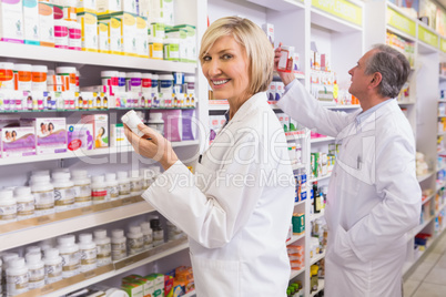 Pharmacists in lab coat looking at medicine