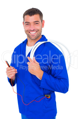 Smiling electrician with wire roll and multimeter