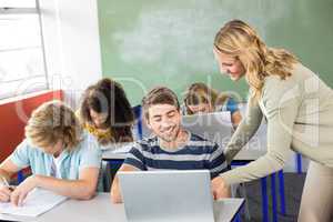 Teacher helping student in class