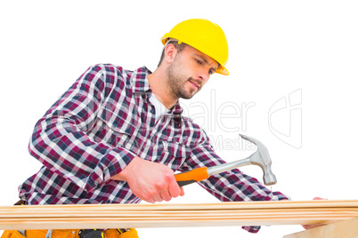 Handyman using hammer on wood