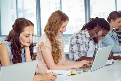 Fashion students using laptop