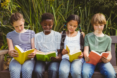 Children reading books at park