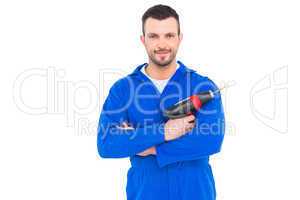 Confident handyman holding power drill