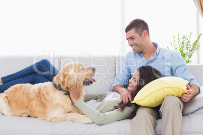 Couple with dog on sofa