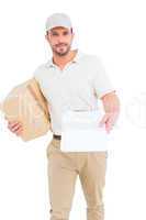 Delivery man with cardboard box showing clipboard