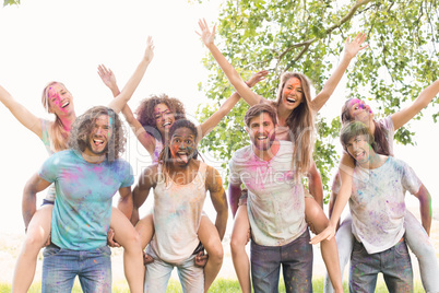 Happy friends covered in powder paint