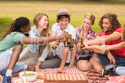 Happy friends in the park having picnic