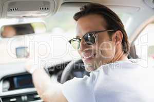 Smiling man using satellite navigation system