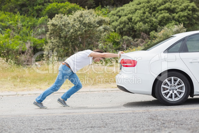 Man pushing his car