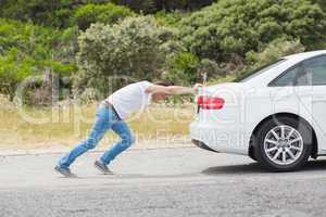 Man pushing his car