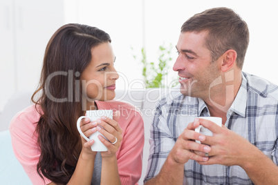 Couple looking at each other while having coffee