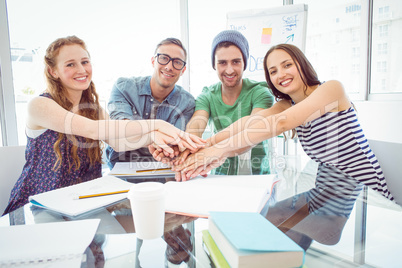 Fashion students high fiving together