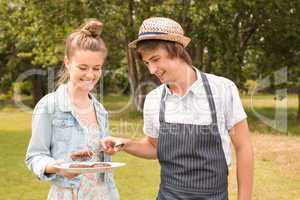 Happy friends in the park having barbecue