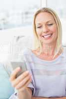 Woman text messaging through smart phone