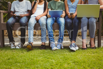 Children using technologies at park