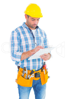 Manual worker writing on clipboard
