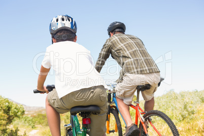 Father and son biking through mountains