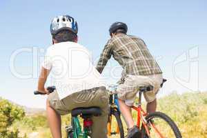 Father and son biking through mountains